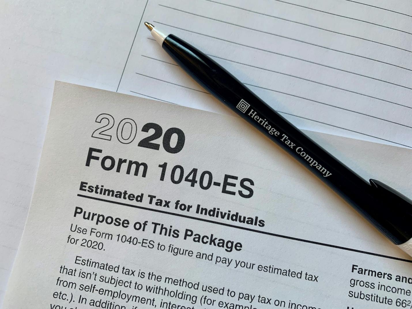 a pen sitting on top of a tax form